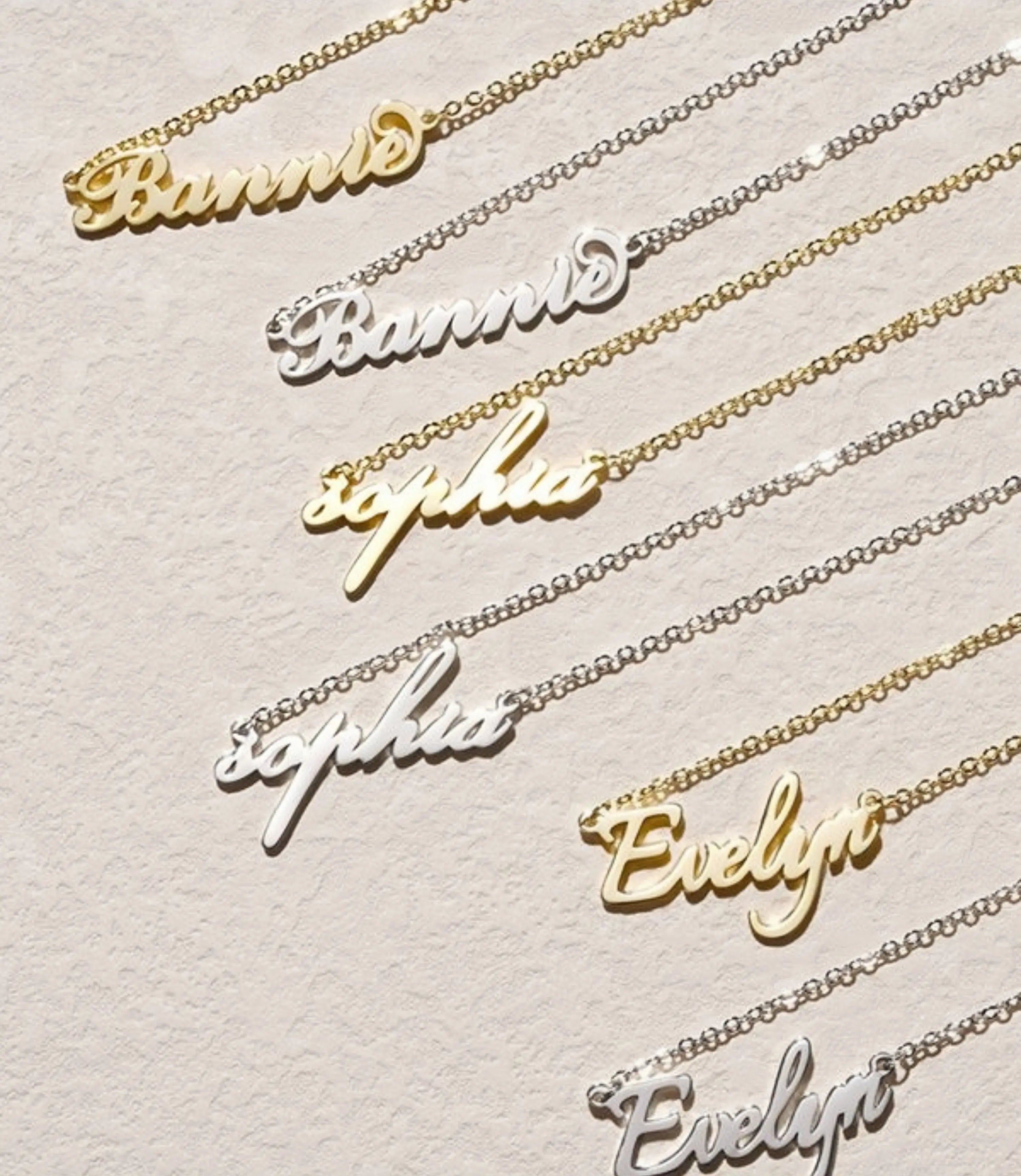 Gold and silver personalized name bracelets with 'Bannie,' 'Sophia,' and 'Evelyn' in elegant script