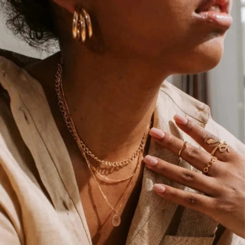 Women wearing Kyerlyn necklaces, rings and earrings